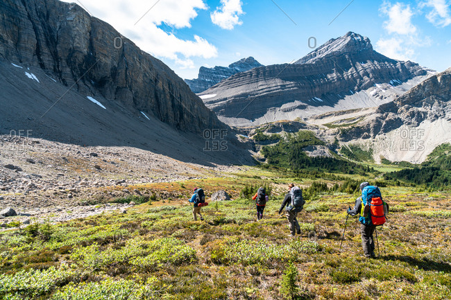 Group of Trekkers Descend into Remote Alpine Valley Near Banff