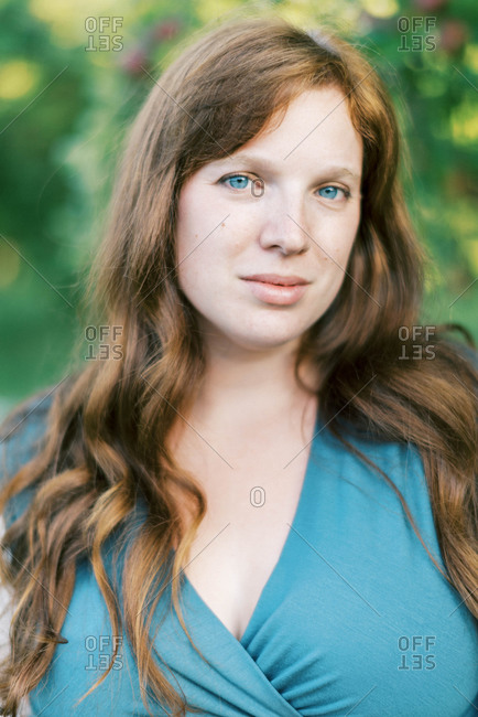 A red haired fair blue eyed woman looking into the camera