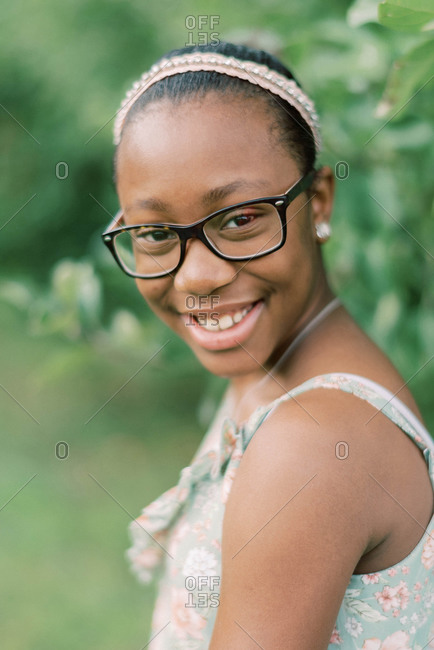 Portrait of a beautiful happy tween girl with glasses