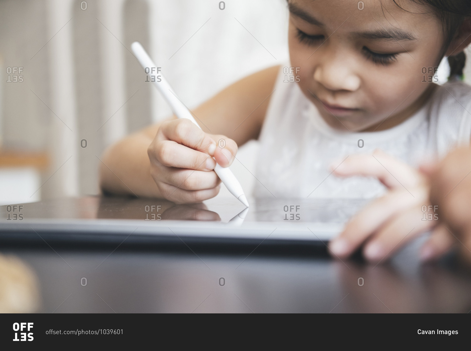 Little girl with tablet and stylus learning drawing online