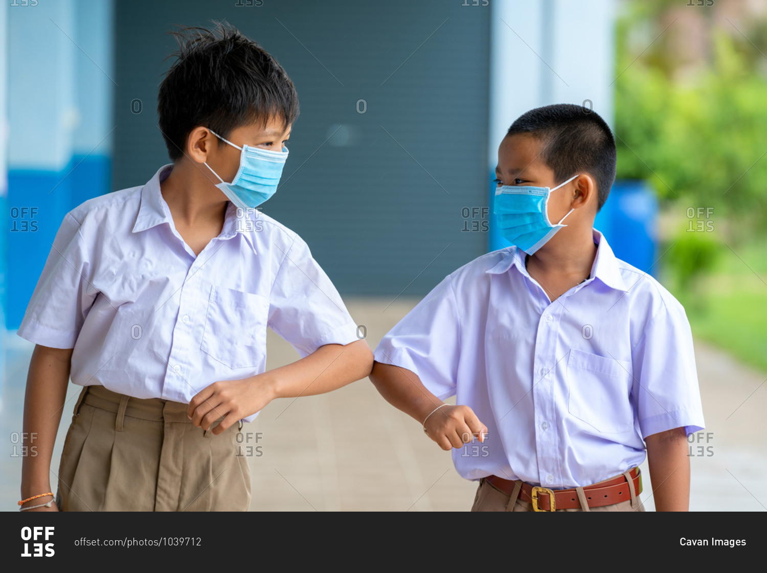 Asian children in school uniform wearing protective masks