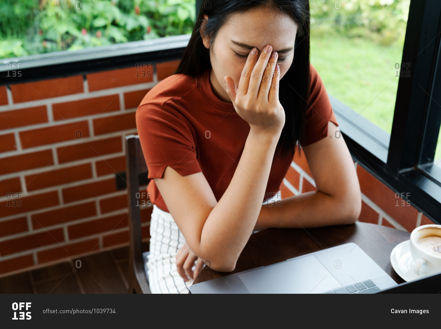 Woman headache after long working on laptop.