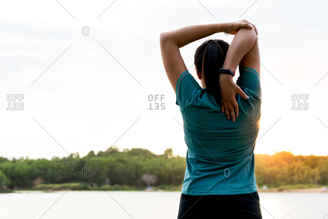 Sport woman is stretching muscle after workout