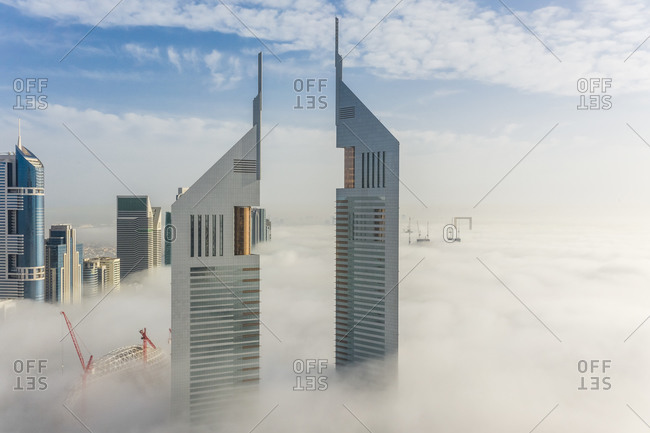 March 29, 2019: Aerial view of misty Emirates Office Tower skyscrapers in Dubai, United Arab Emirates.
