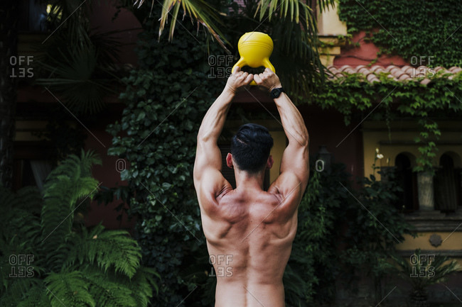 Premium Photo  Shirtless macho man in santa hat holding gifts