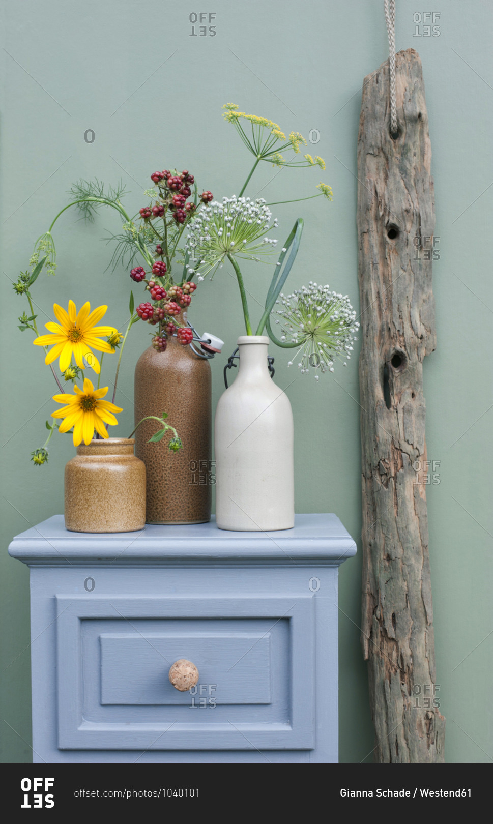 Drawer with DIY champagne cork handles- driftwood and flowers blooming in stoneware bottles
