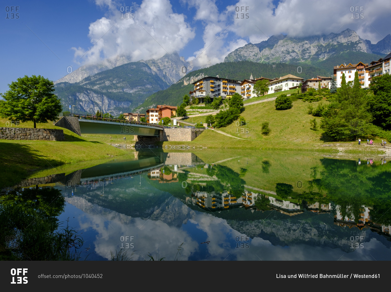 Italy- Trentino- Molveno- Town reflecting on shiny surface of Lago di Bior in summer