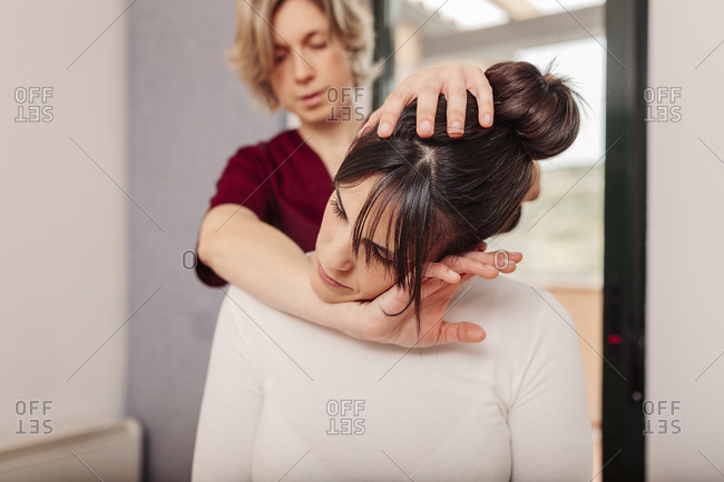 Physiotherapist treating patient in office setting
