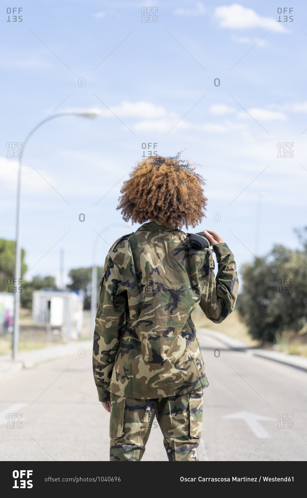 Female military officer standing on street during sunny day
