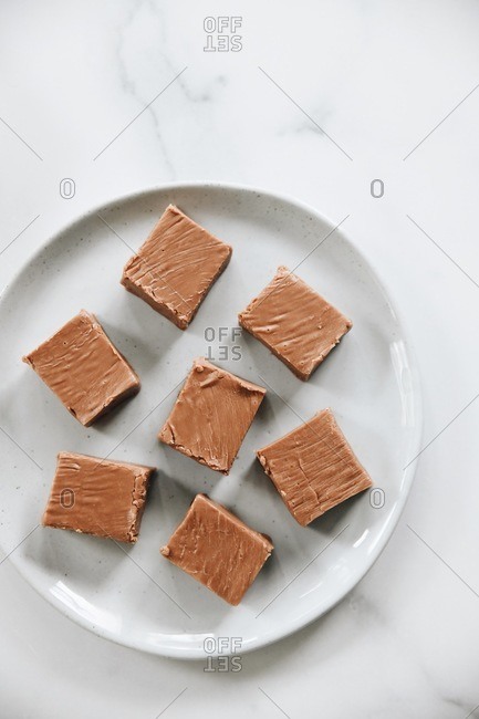 Top down view of fudge squares on white plate