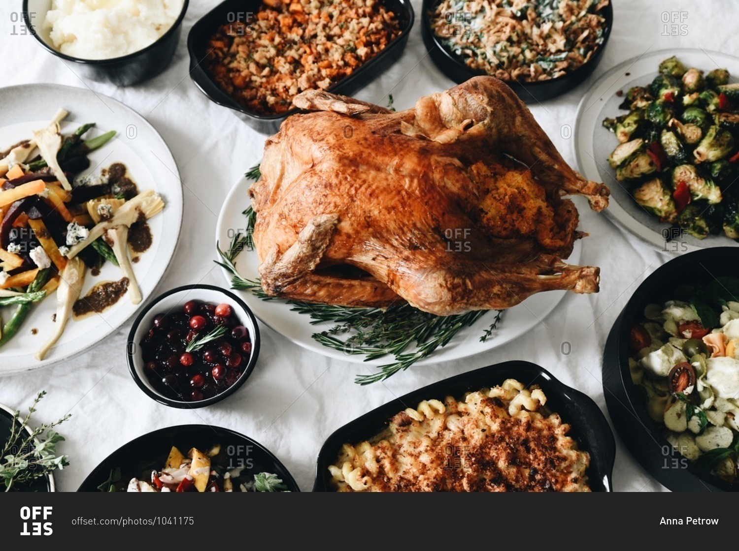 Overhead view of traditional Thanksgiving dinner food served on a table in front of a window