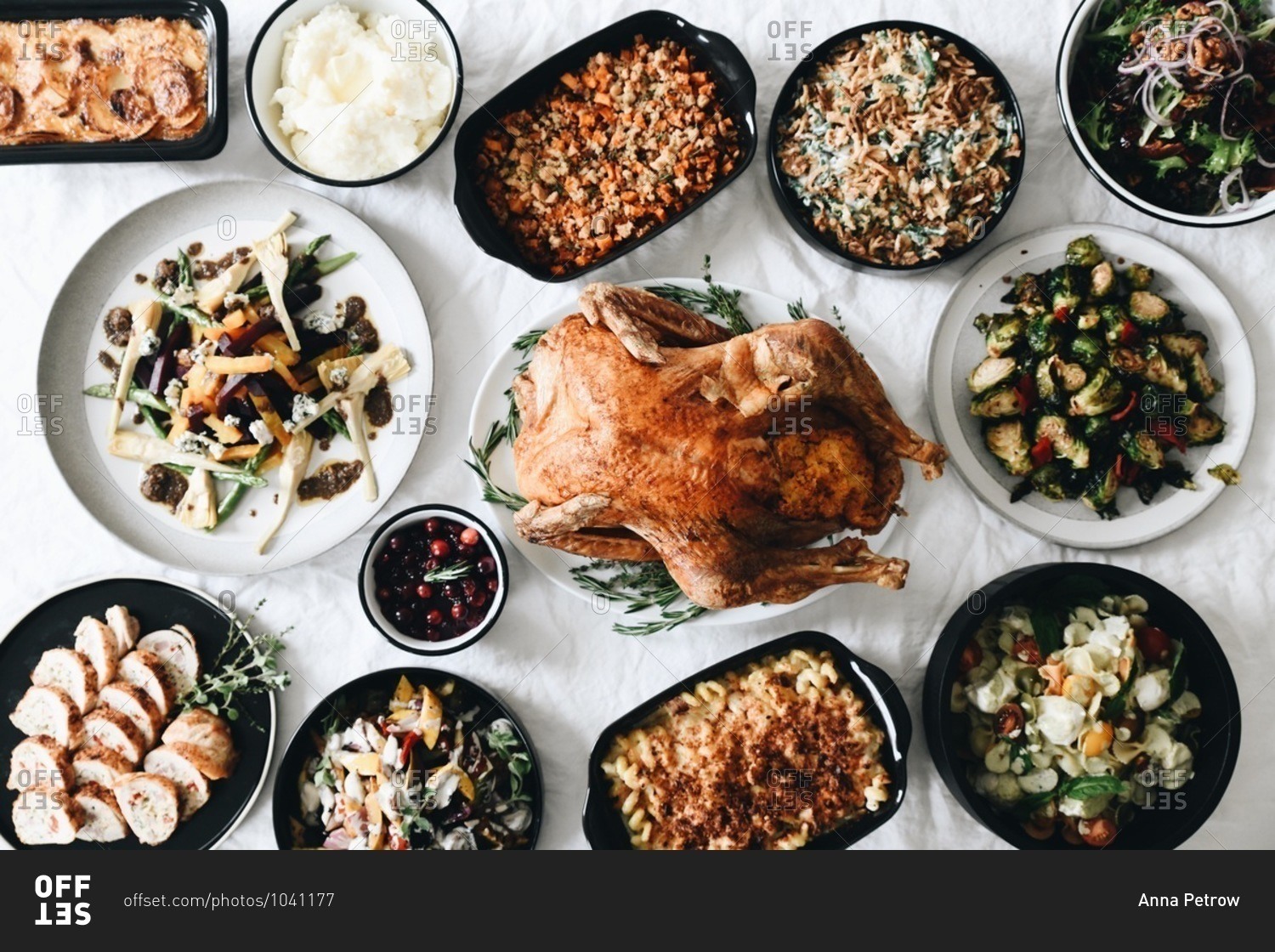 Top view of traditional Thanksgiving dinner food served on a table in front of a window