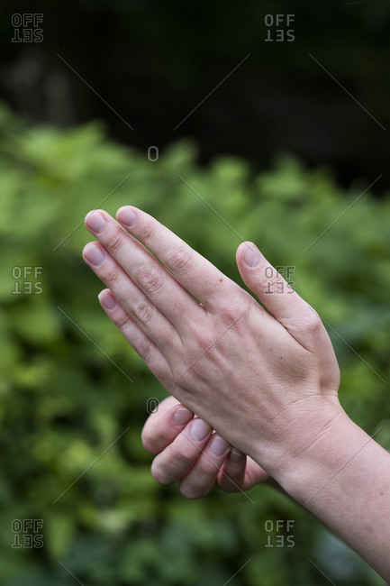 Close up of a man's hands, together and pressing meridian points on the hands, therapy