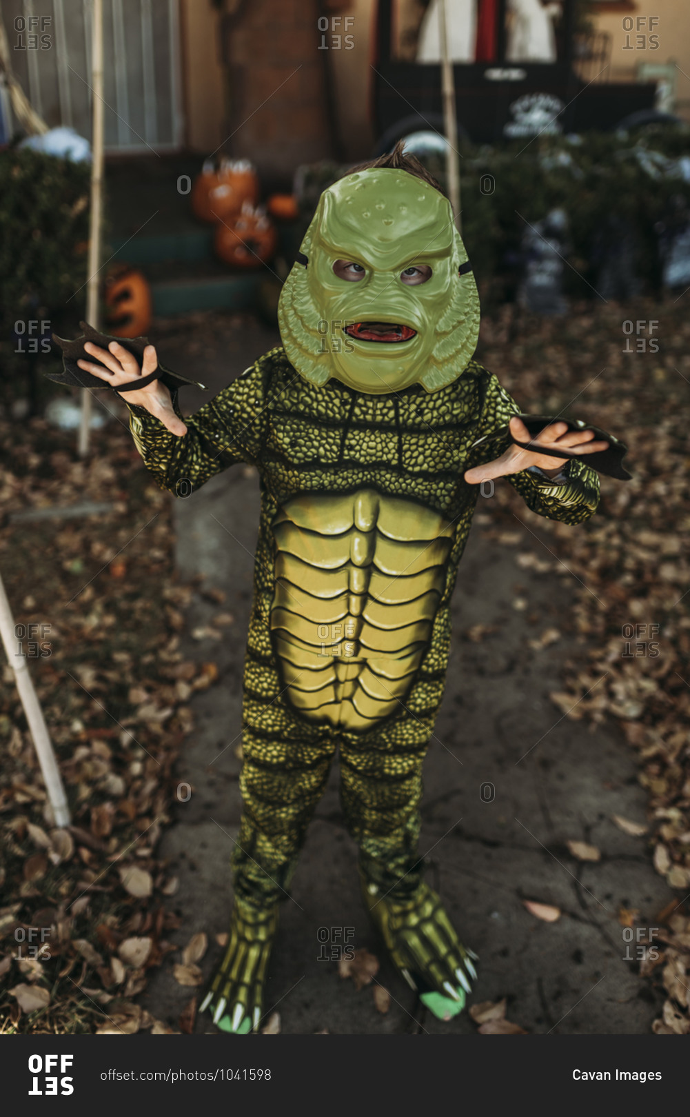 Young boy dressed as sea monster posing in costume at Halloween