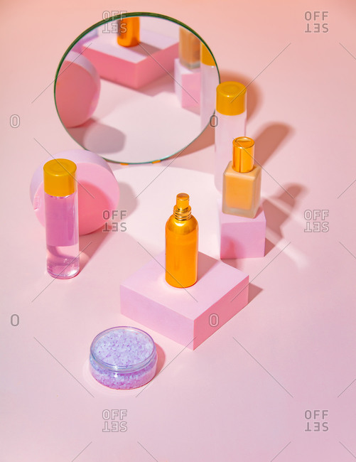 Perfume, oil and cream on a stands near mirror Cosmetics