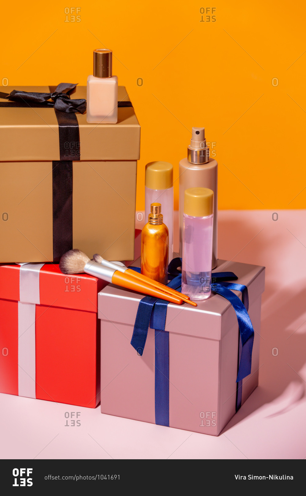 Cosmetic items and holiday gift boxes on a table