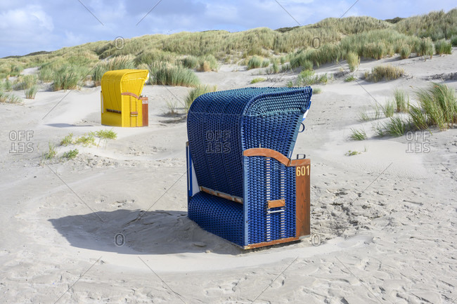 Germany, Lower Saxony, East Frisia, Juist, beach chairs isolated on the edge of the dunes.