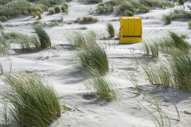 Germany, Lower Saxony, East Frisia, Juist, beach chairs isolated on the edge of the dunes.