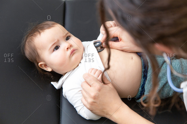 Little beautiful baby having a medical examination by a woman pediatrician with a stethoscope