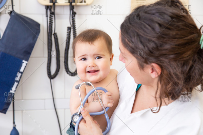 Little beautiful baby having a medical examination by a woman pediatrician with a stethoscope