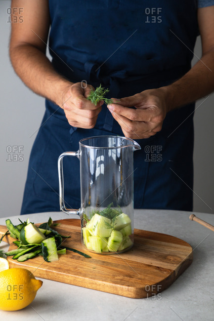 Premium Photo  Man pouring nondiary milk in blender with cut bananas when  making smoothie