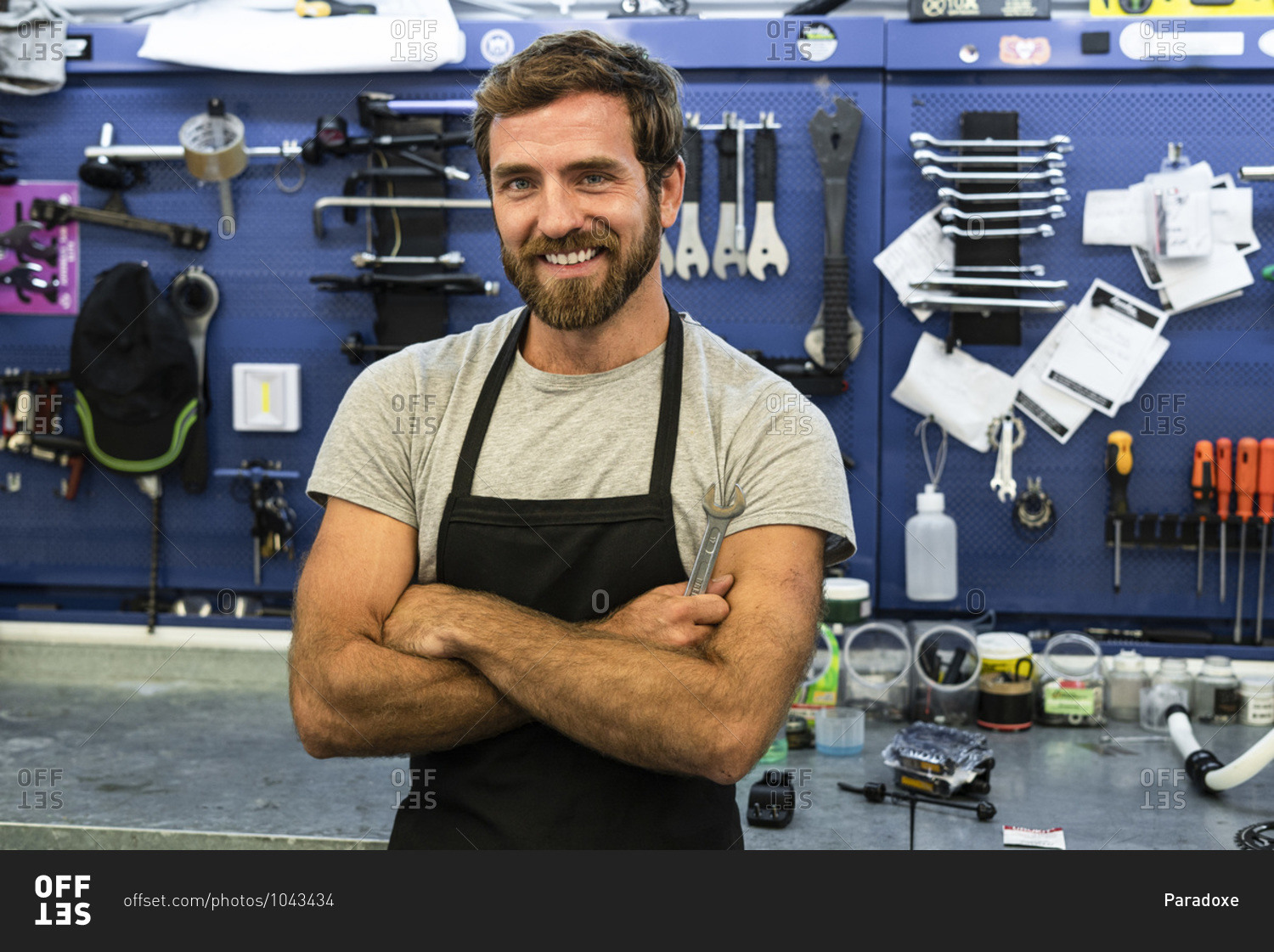 Smiling mechanic standing in workshop