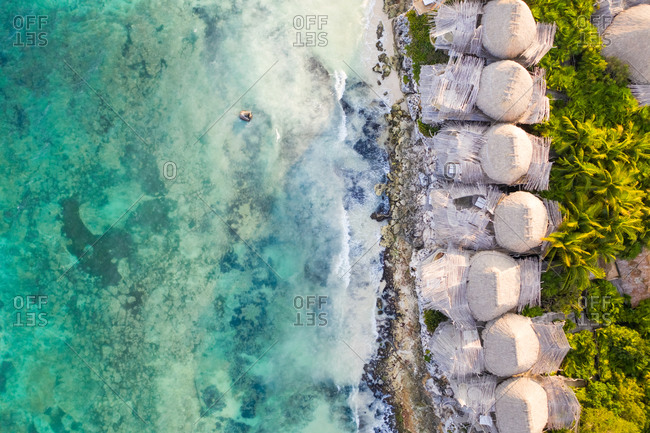 Aerial view of bungalow resorts on the Tulum coast in Mexico.