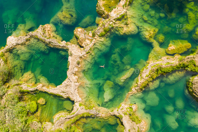 Aerial view of woman in swimsuit bathing in the El Salto waterfalls, Mexico.