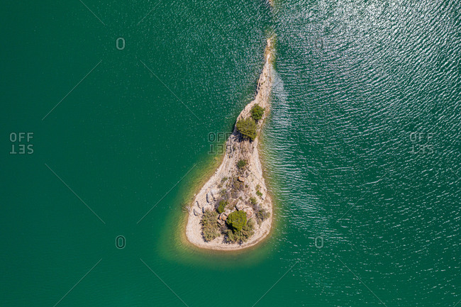 Aerial view of small island on Guadalhorce valley lake, Malaga, Spain.