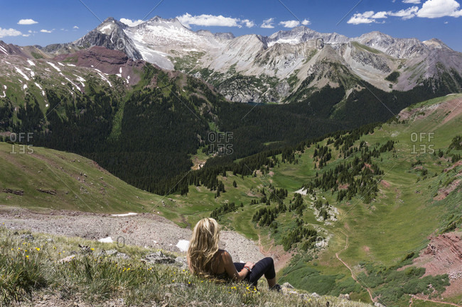 Female hiker looking at view while relaxing on mountain
