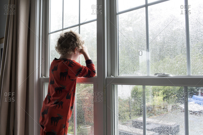 Premium Photo  Unrecognizable young man stands by the window