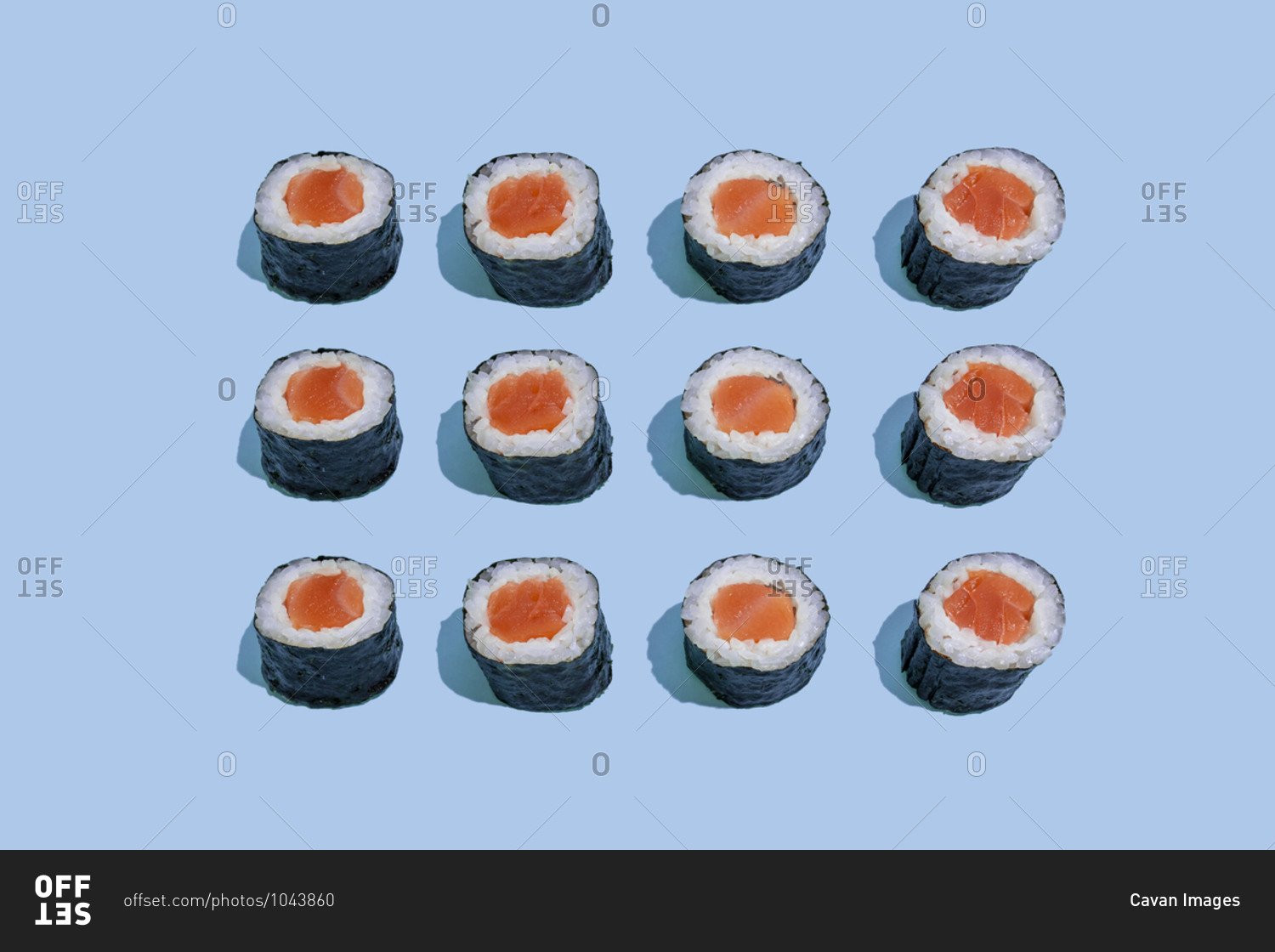 Salmond sushi makis pattern on blue background with shadows