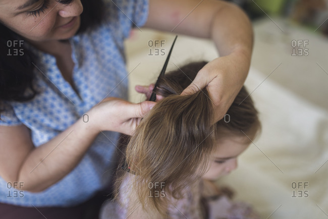 Back view of woman's brown hair tied in a ponytail stock photo - OFFSET