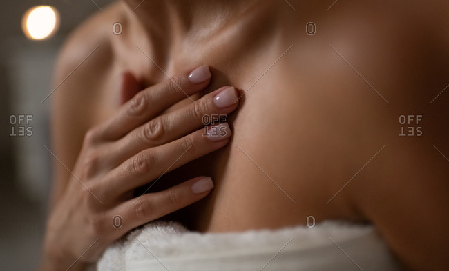 Anonymous woman touching clean skin