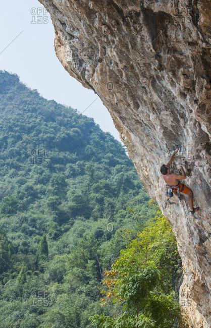 Man climbing at Odin's Den in Yangshuo, a climbing Mekka in China