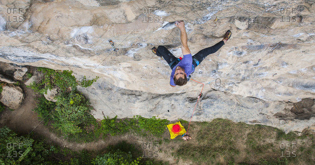 Man climbing on the limestone cliff "White Mountain" in Yangshuo