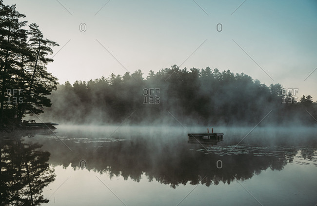 Mist rising off of a lake in the morning in Ontario, Canada.