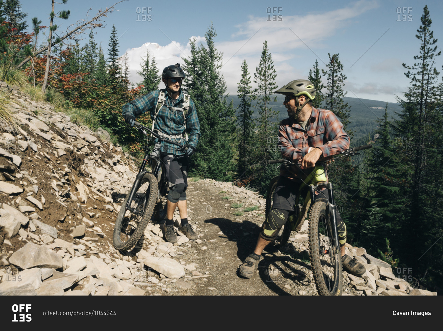 Two bikers take a break on the trail at the Timberline Bike park in OR