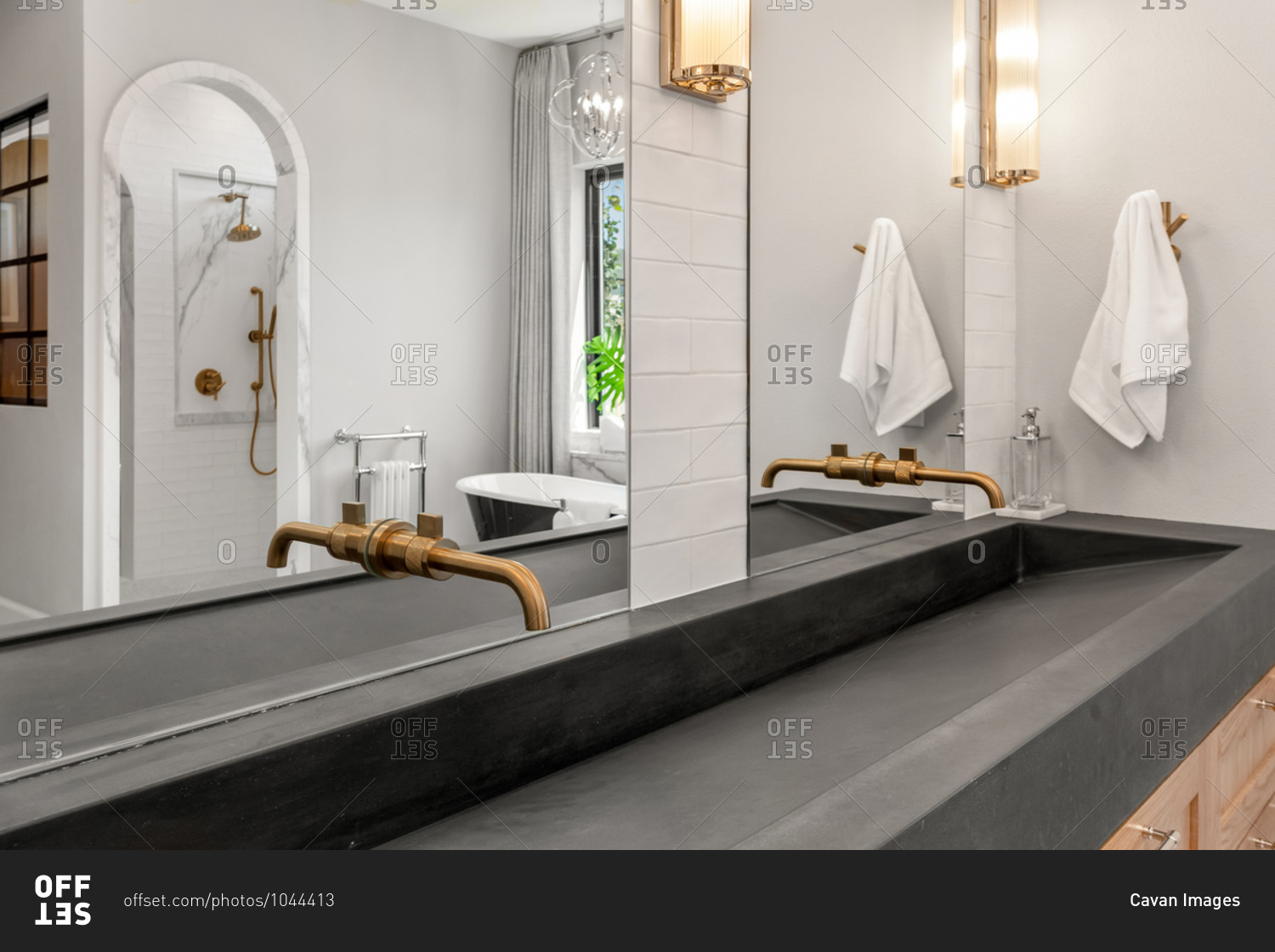 Bathroom in luxury home with concrete sink and double vanity