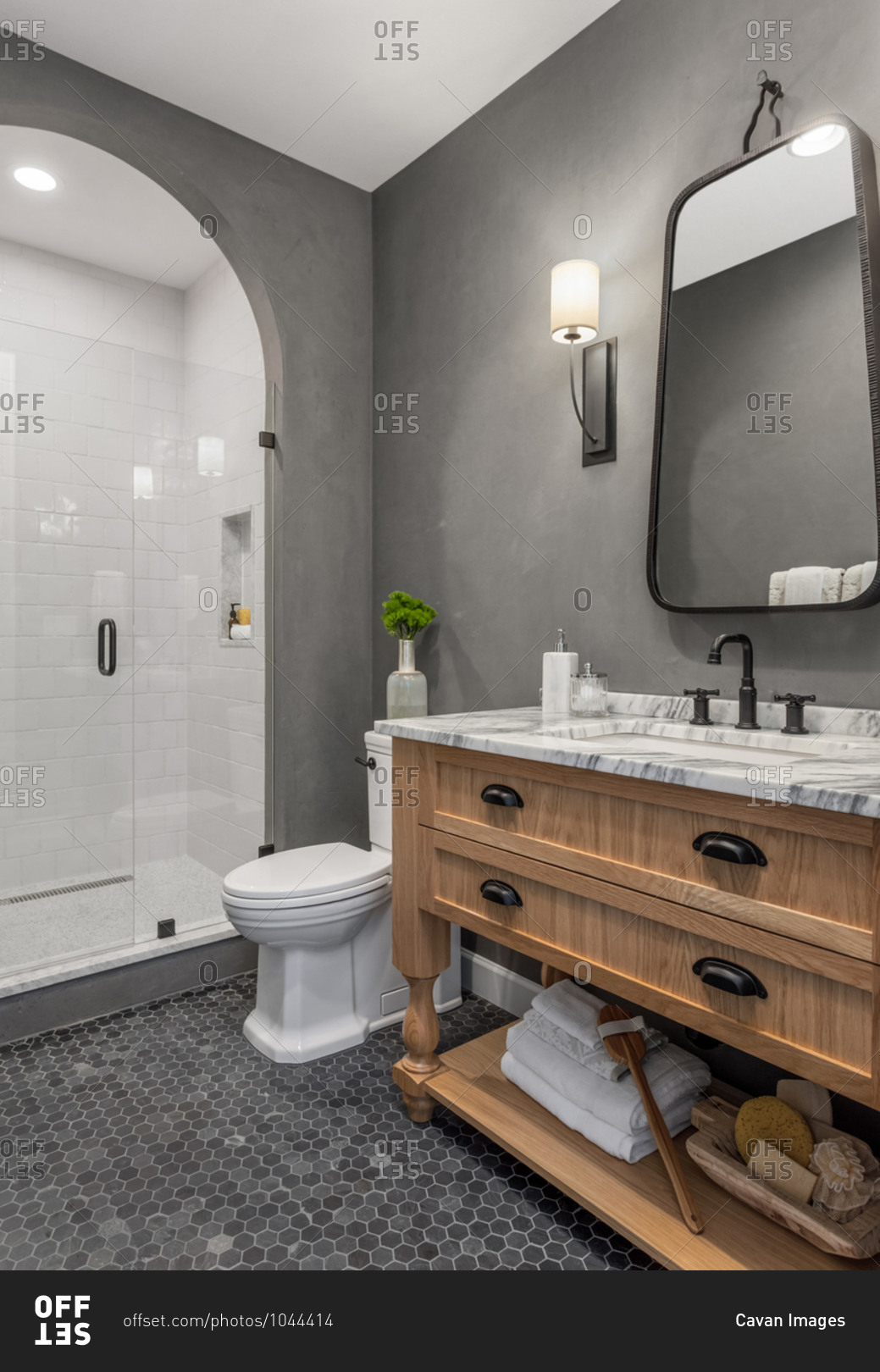 Bathroom in home with shower, vanity, mirror, sink, and tile floor