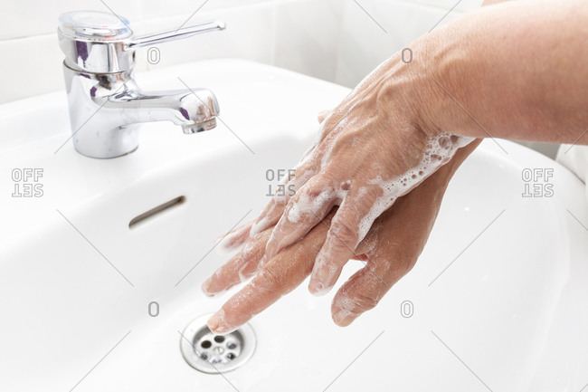 Woman washing her hands and disinfecting them for Coronavirus disease
