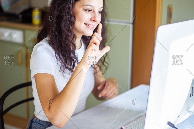 Girl speaking sign language on video call