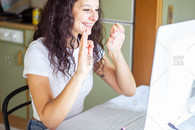 Girl speaking sign language on video call