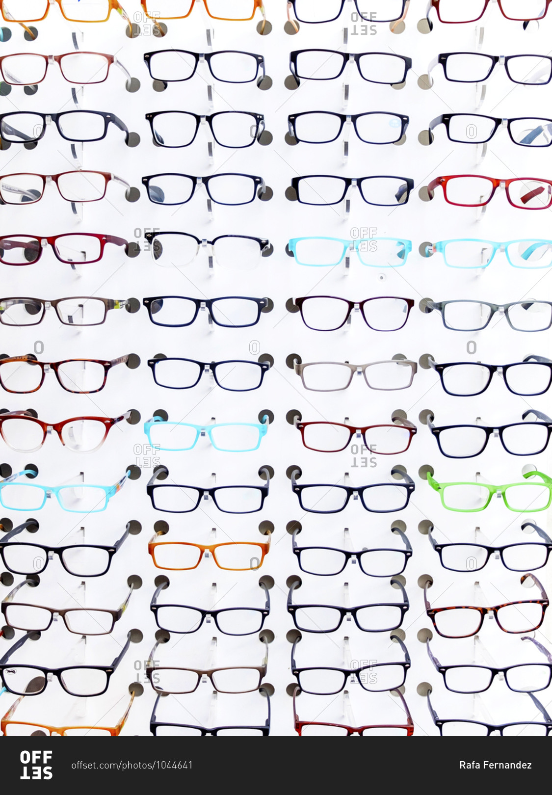 Exhibition of glasses in wall rack at optical shop
