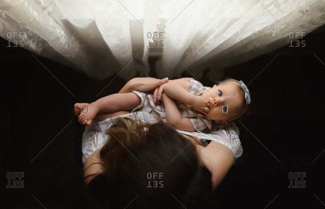 Overhead shot of baby girl in mother's arms