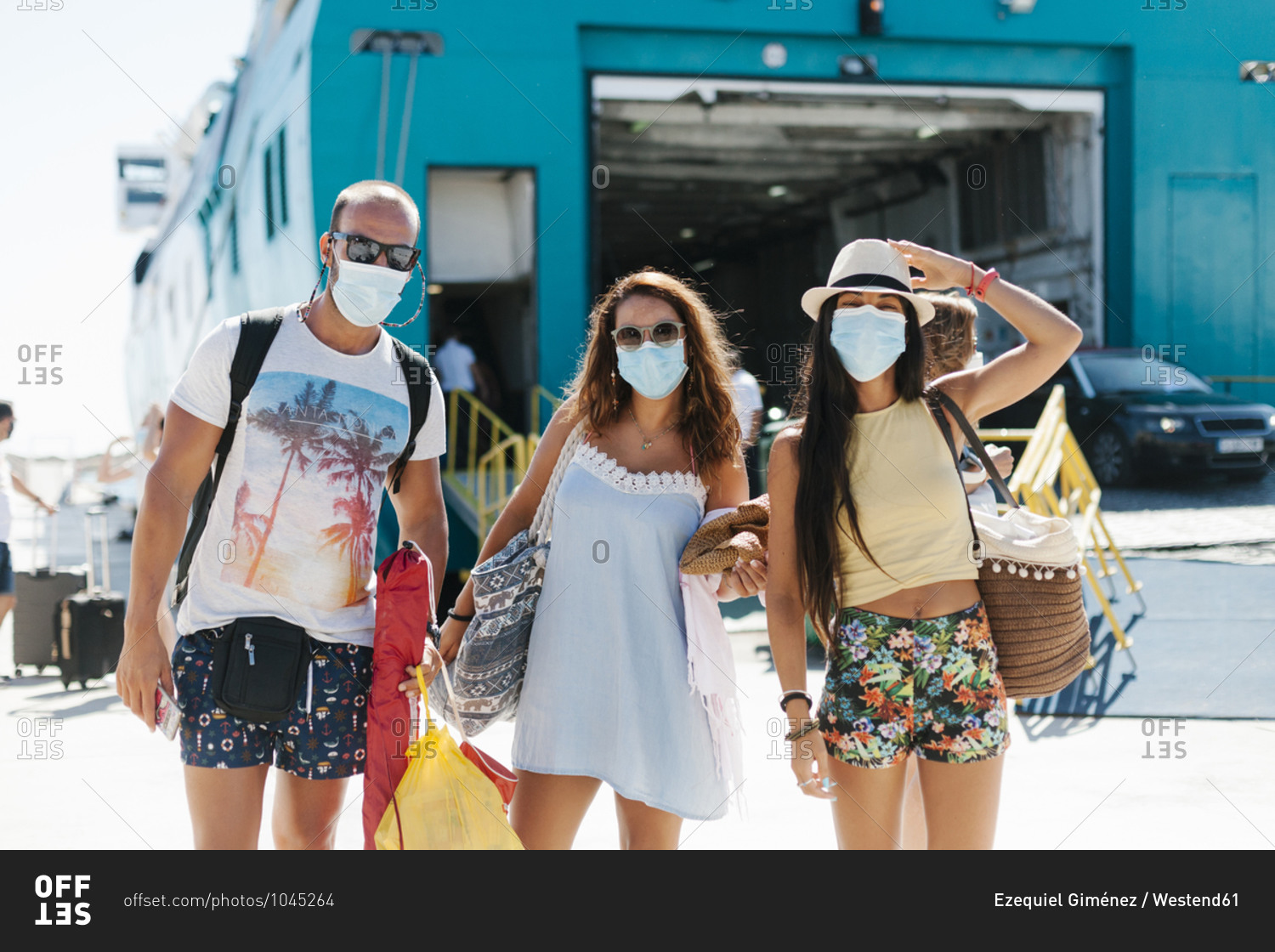 Friends wearing masks standing against cruise ship at harbor