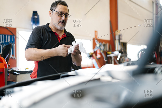 Male mechanic repairing car in auto repair shop