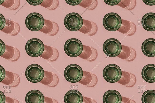Pattern of green glasses of carbonated water