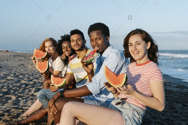 group of friends having fun on beach