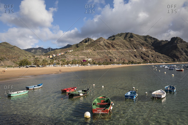 January 25, 2020: colorful fishing boats in front of the playa de las teresitas beach and the anaga mountains, san Andres, tenerife, canary islands, Spain